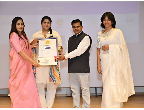 Simran Bagwan receiving the Outstanding Contribution in Education Award at an award ceremony, April 2024